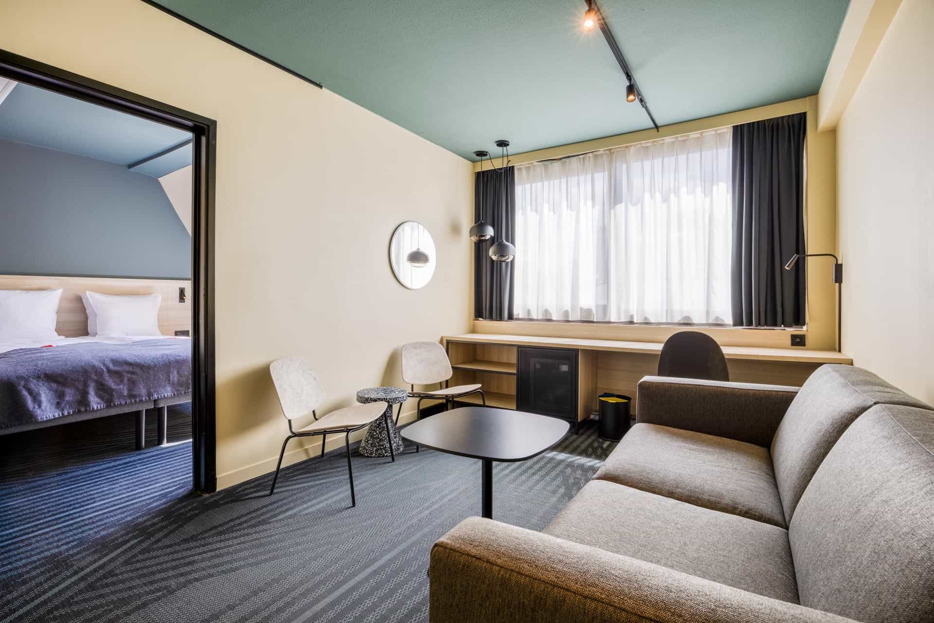 Jr suite in Citybox Brussels, seating area with sofa and chairs